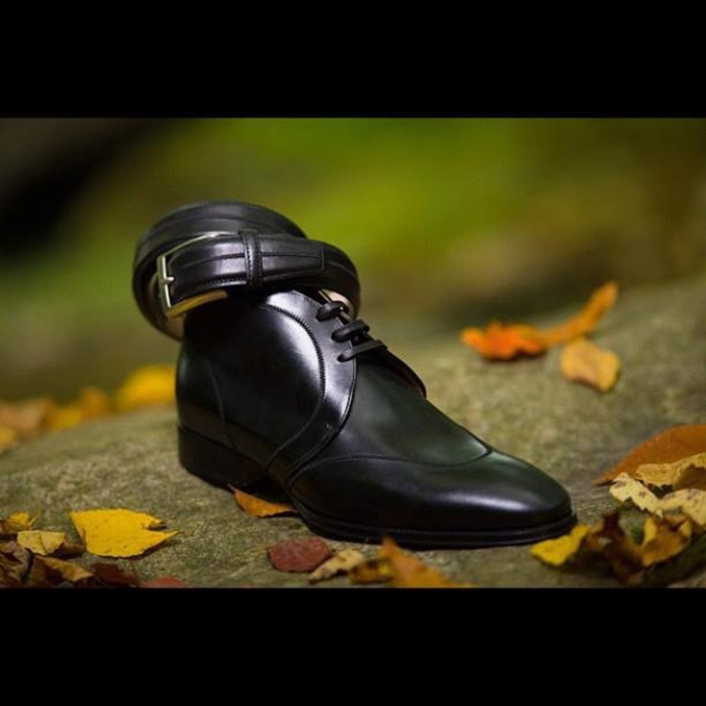 Black leather men’s boots with matching belt.
